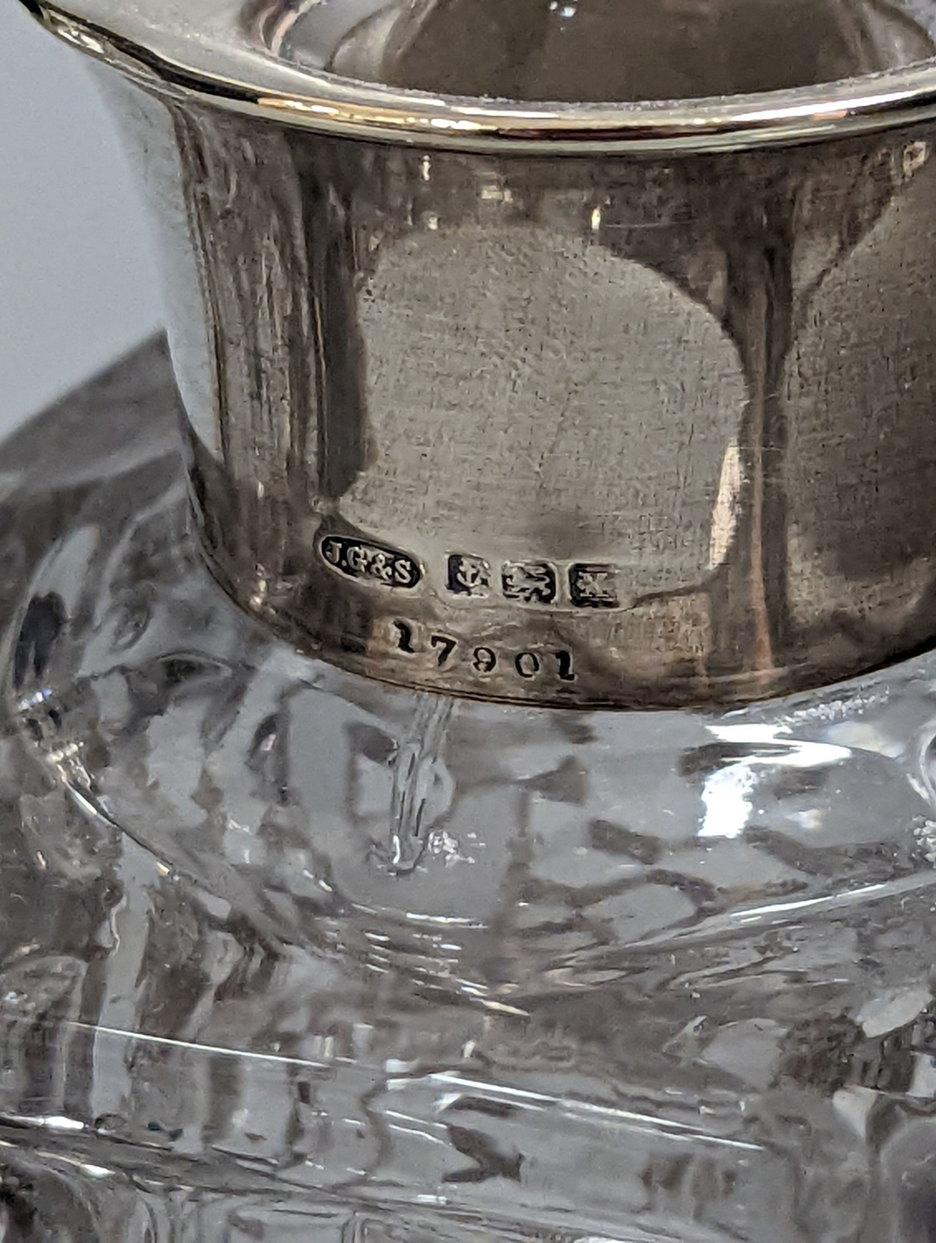 A pair of silver mounted cut glass spirit decanters and a ‘GIN’ spirit label